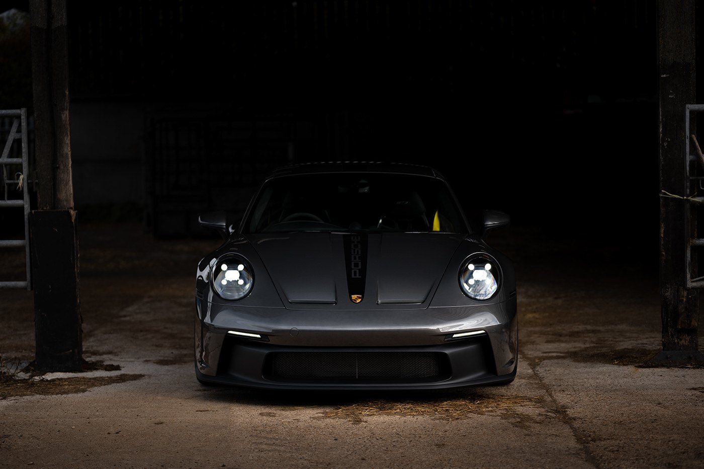 Porsche 911 GT3 emerging from a dark garage